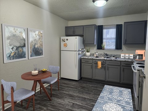 A kitchen with a table and chairs.