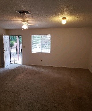 an empty living room with a window and a door