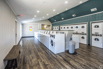 a spacious laundry room with washers and dryers