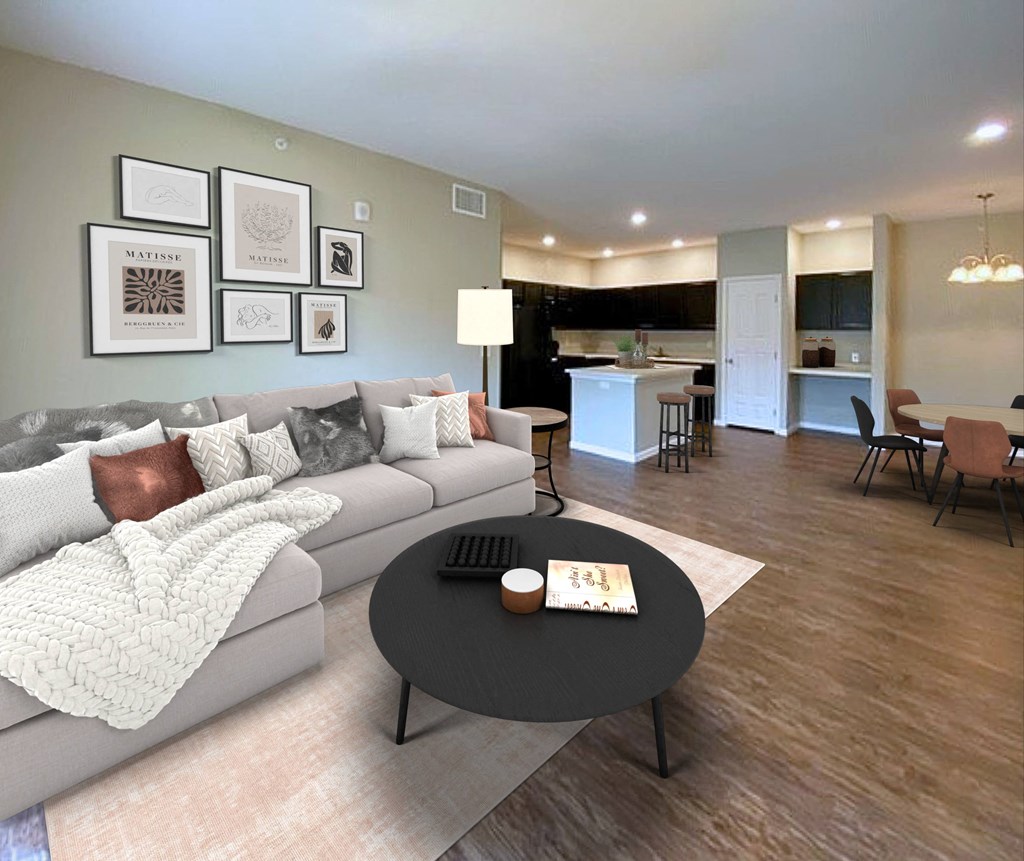A modern living room with a grey couch and a coffee table in the center.
