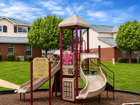 A playground with a slide and a sign that says "Welcome".