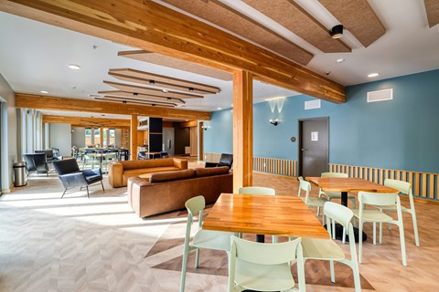 A modern living room with a wooden ceiling and furniture.