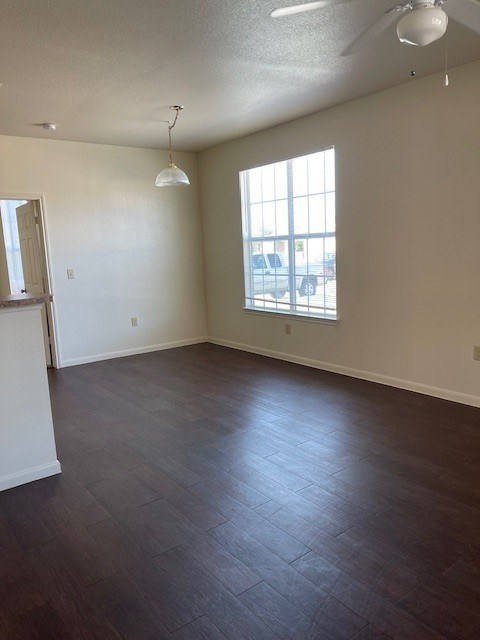 A room with a ceiling fan and a window.