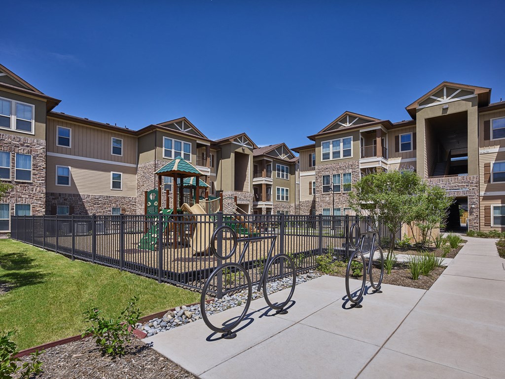 A row of houses with a playground in the foreground.