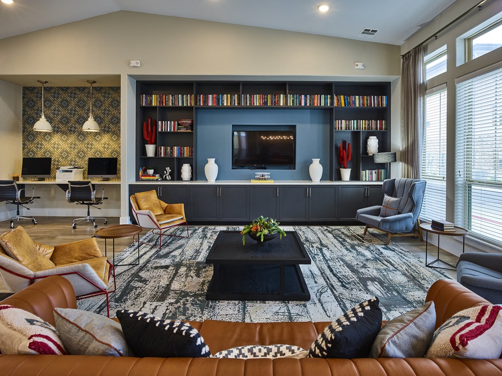 A living room with a brown leather couch and a black coffee table in the center.