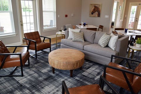 a living room with a couch and chairs and a table
