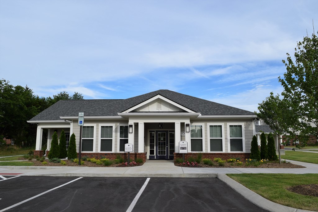 the front of a house with a driveway and a parking lot