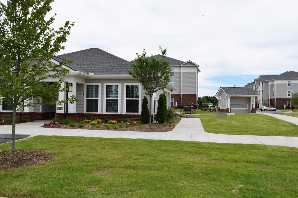 a home in a subdivision with grass and a sidewalk