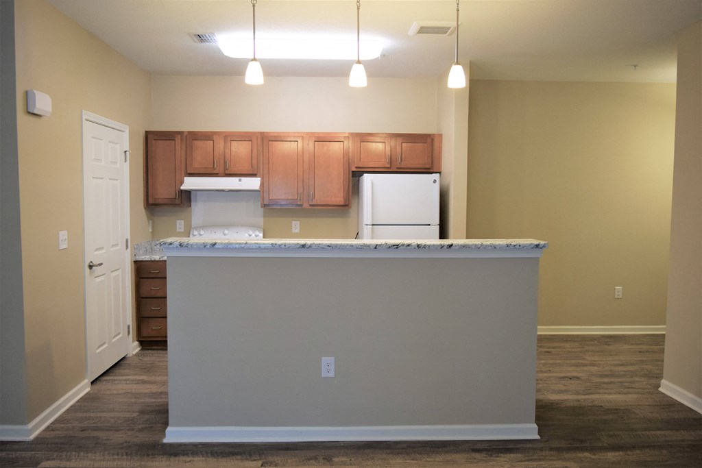 an empty kitchen with an island in the middle