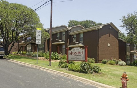 A house with a sign that says Marshall in front of it.