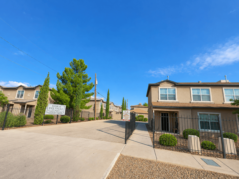 A sunny day at a residential area with a clear blue sky.