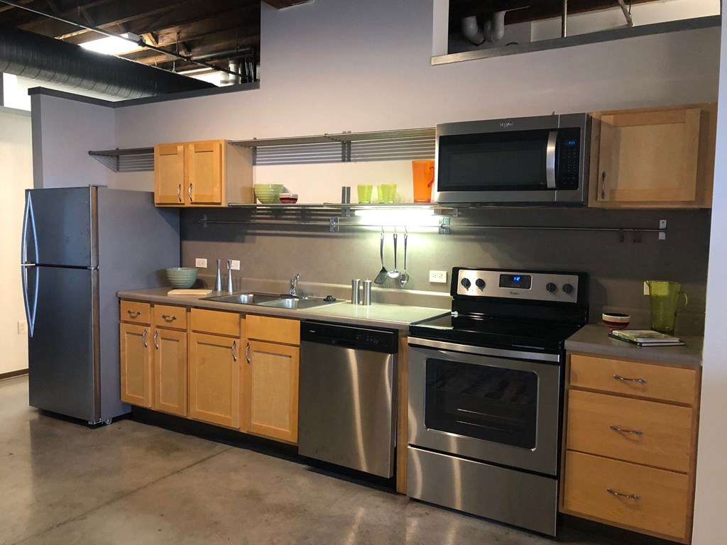 a kitchen with stainless steel appliances and wooden cabinets