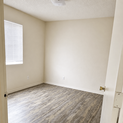 A room with a window and a door.