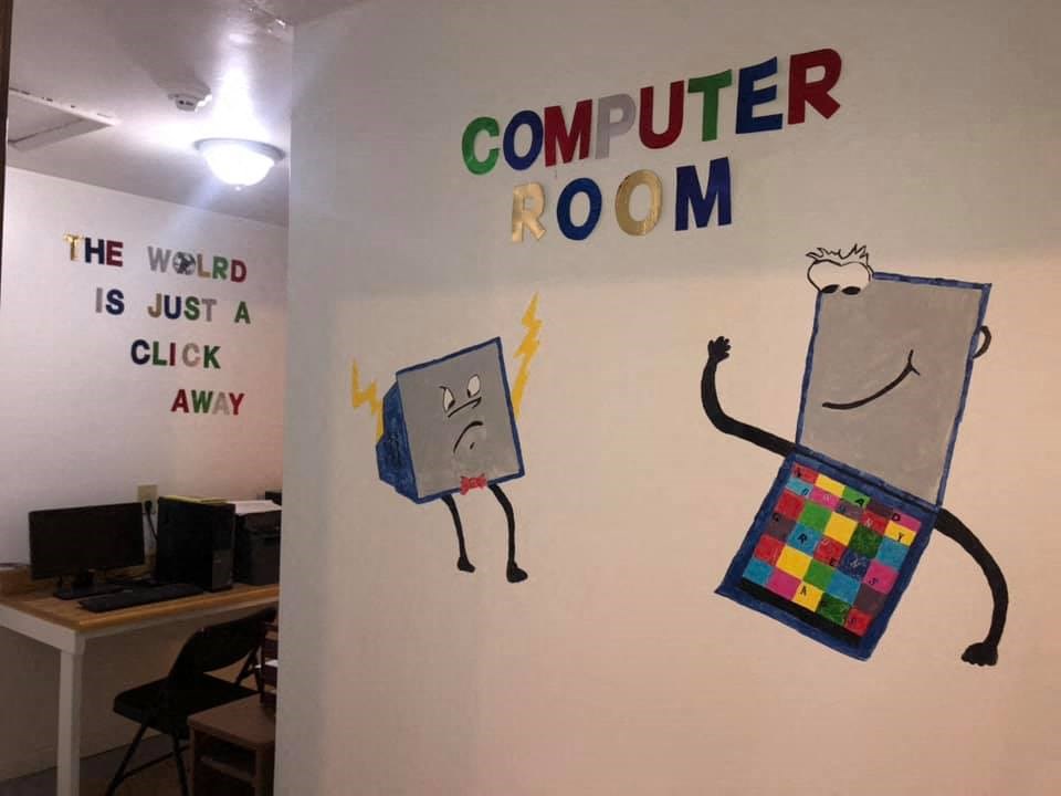 a wall with a computer room painted on it