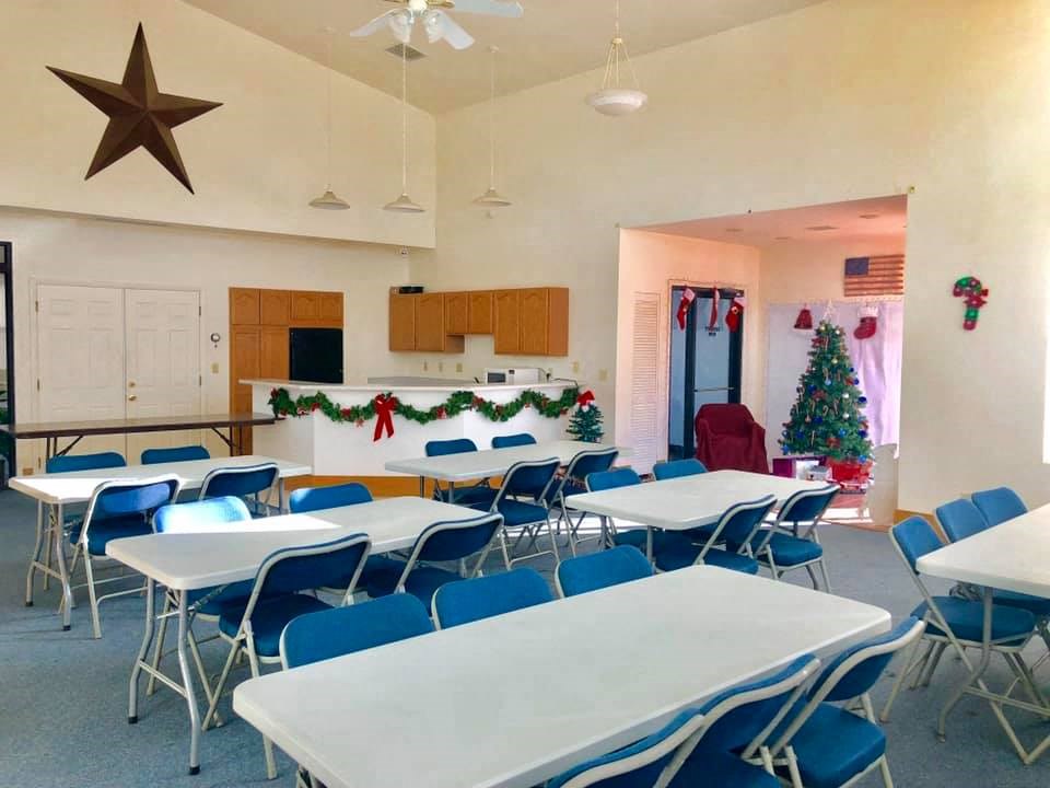 the dining room at christmas with a christmas tree in the corner