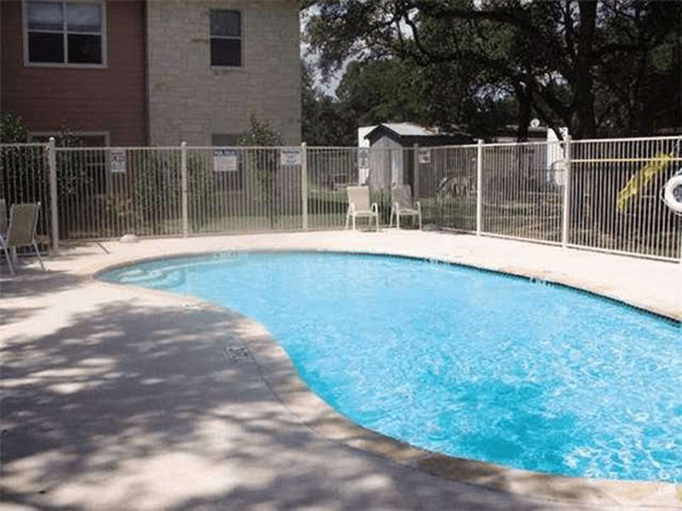 a swimming pool with a fence around it