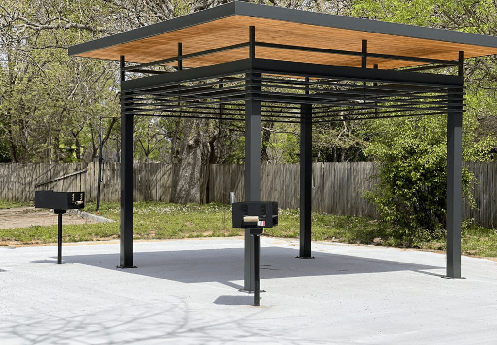 a bus stop with a canopy and two black mailboxes