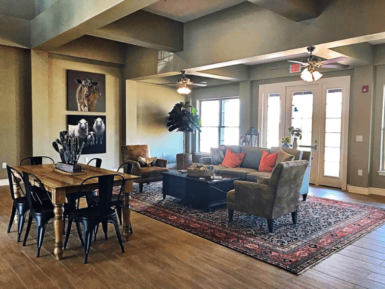 a living room with a dining room table and a couch