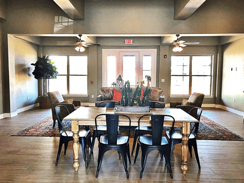 a dining room with a wooden table and chairs