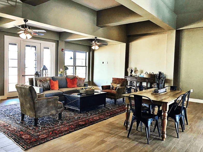 a living room with furniture and a dining room table