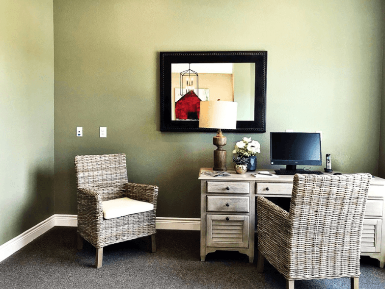 a home office with two chairs and a desk with a computer