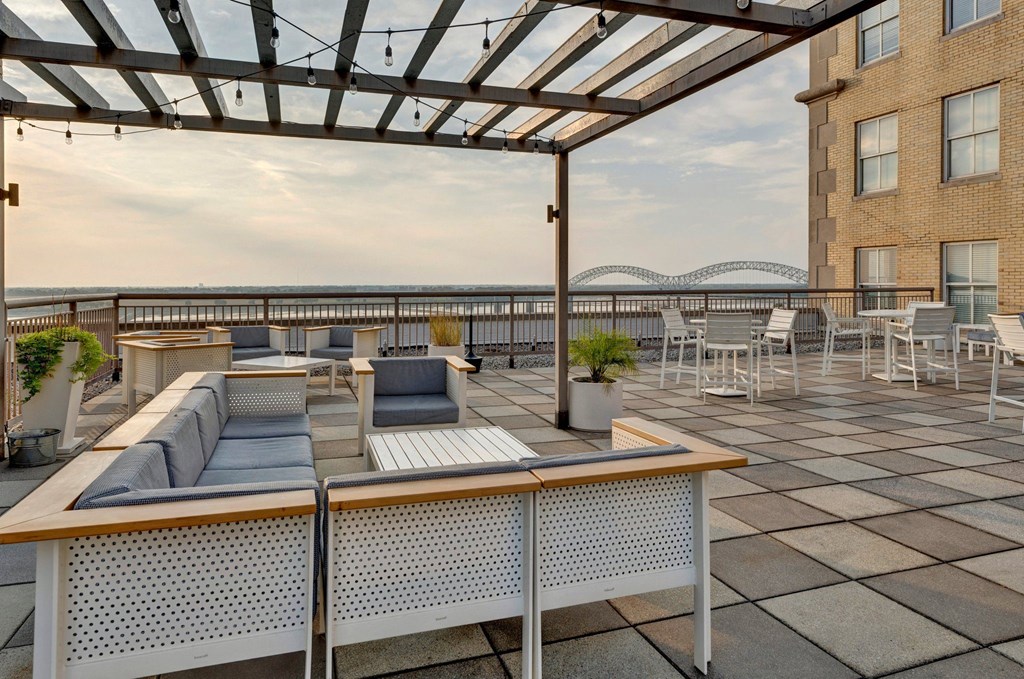 a rooftop terrace with couches and tables and a glass roof at Metro67, TN, 38103