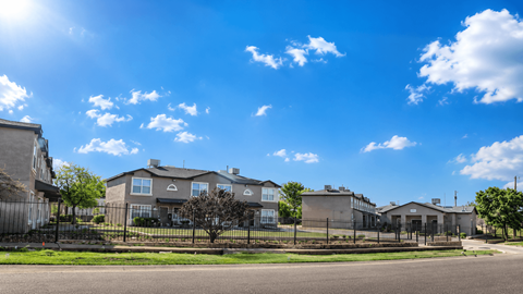 A row of houses with a clear blue sky above them.
