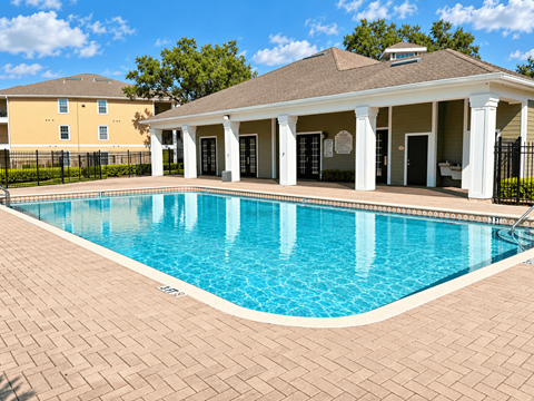A pool with a building in the background.