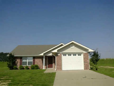 a brick house with a white garage door
