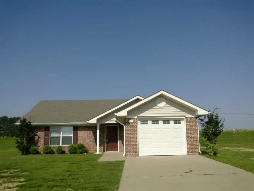 a brick house with a white garage door
