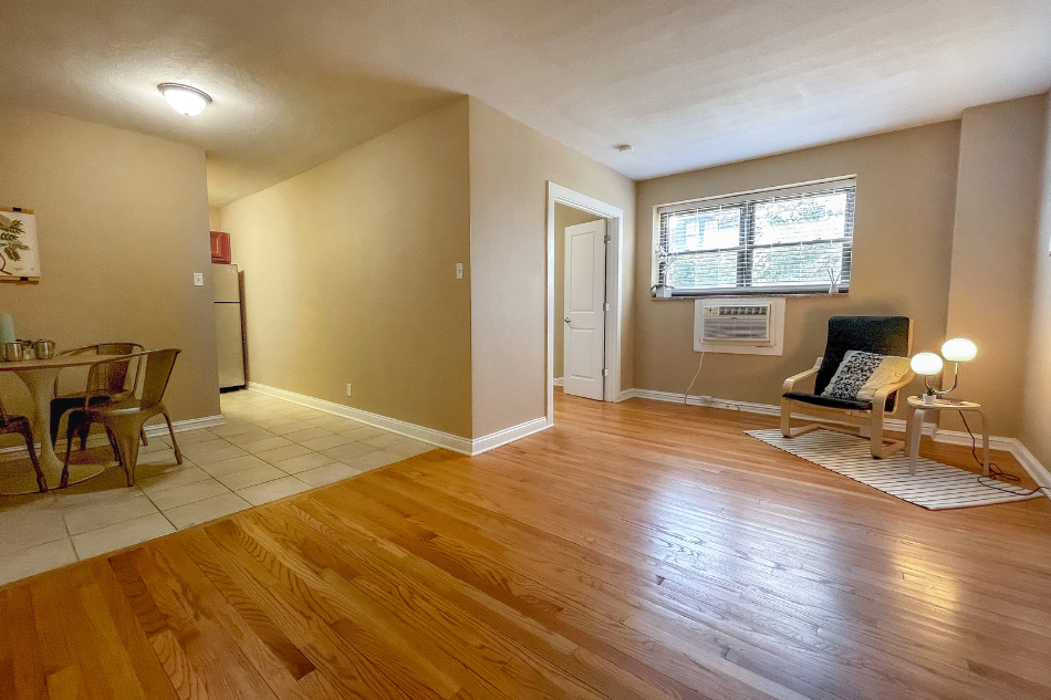 a living room and dining room with wood floors and a window