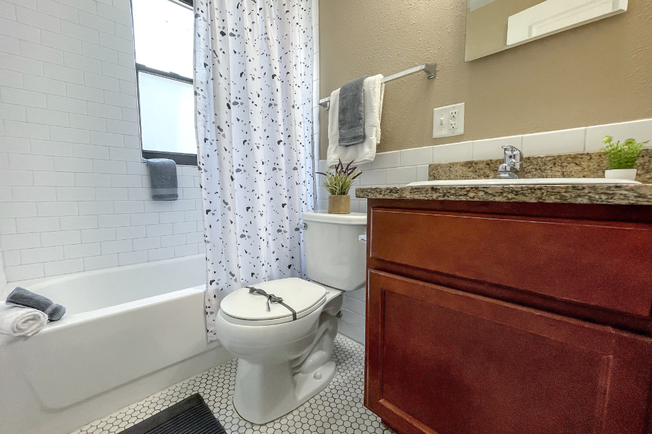 a bathroom with a toilet and a tub and a sink
