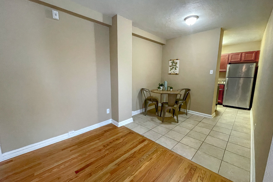 a dining room with a table and a refrigerator