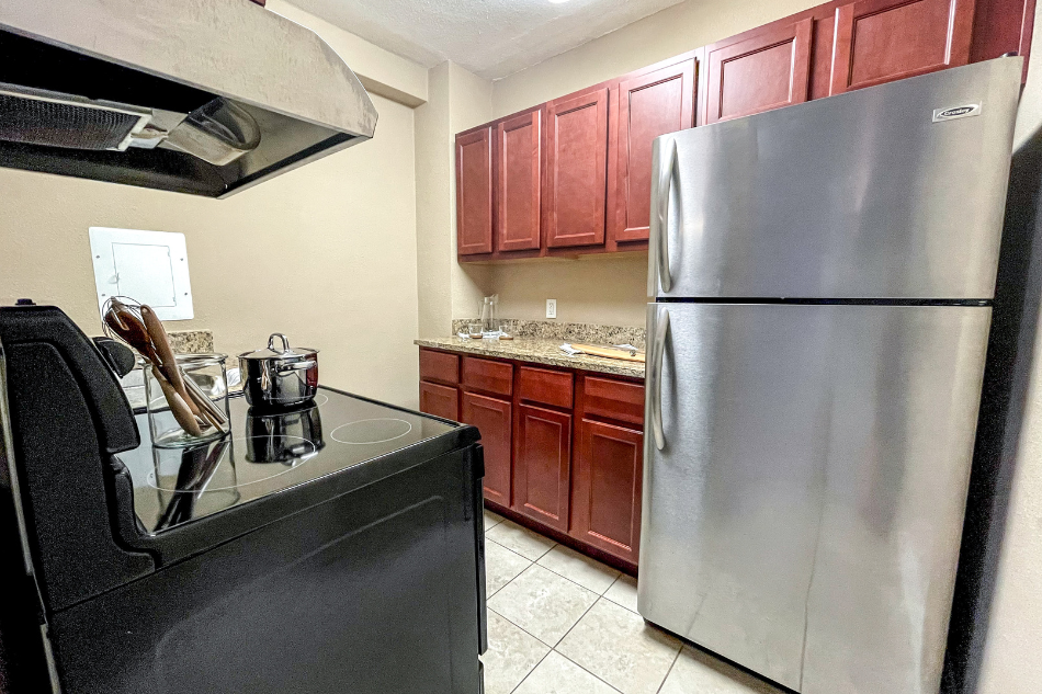 a kitchen with stainless steel appliances and wooden cabinets