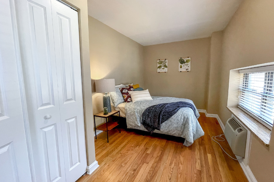 a bedroom with a bed and a window