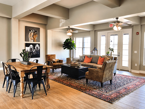 A living room with a wooden table and chairs.