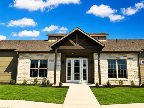A building with a stone facade and a large glass door.