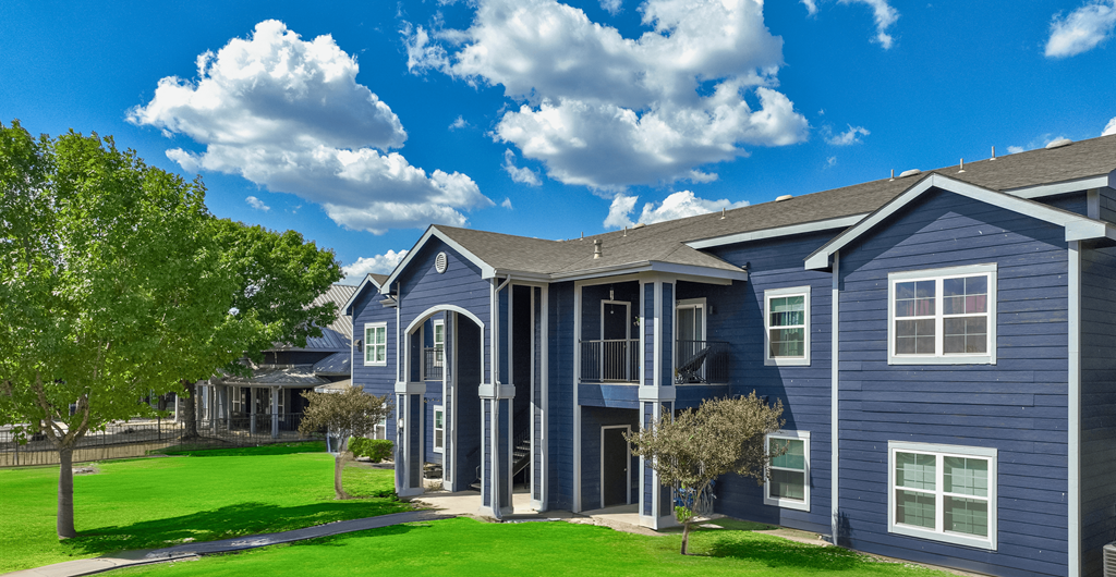 A blue house with a tree in front of it.