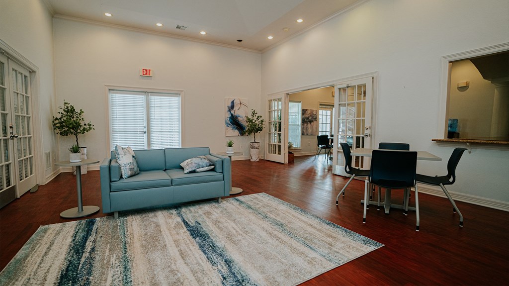 a living room with a blue couch and a rug