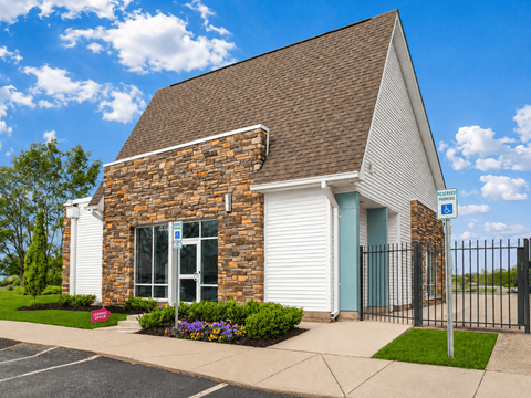 A small church with a parking lot in front.