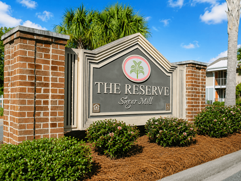 A sign that says "The Reserve Sugar Mill" is in front of a building.