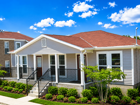 A house with a red roof and a white front porch.