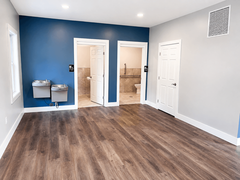 A room with blue walls and wooden floors.