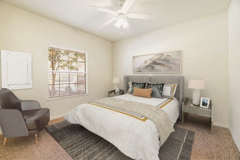 A bedroom with a large bed, a chair, and a painting on the wall.