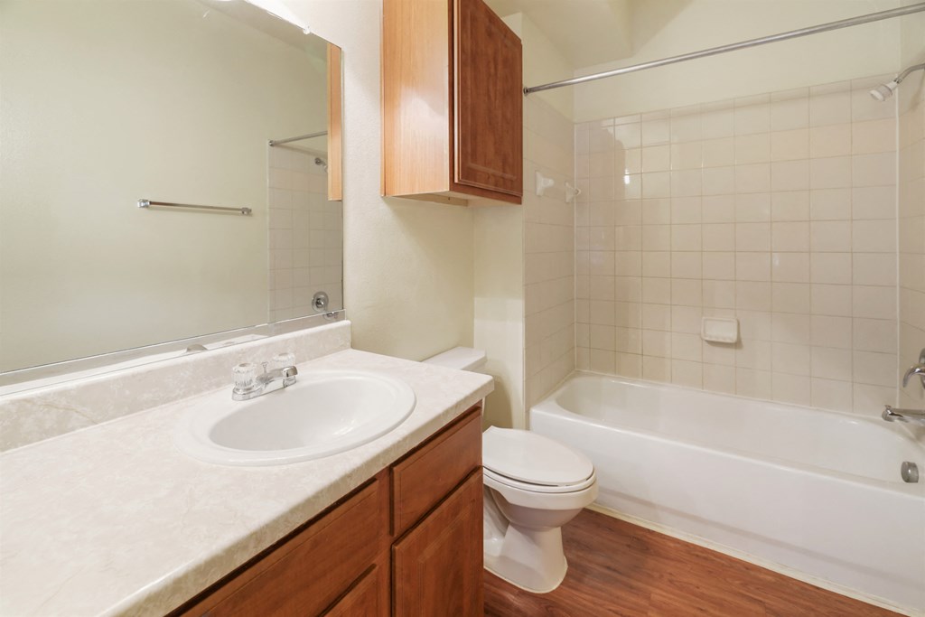 A white sink is on a countertop in a bathroom.