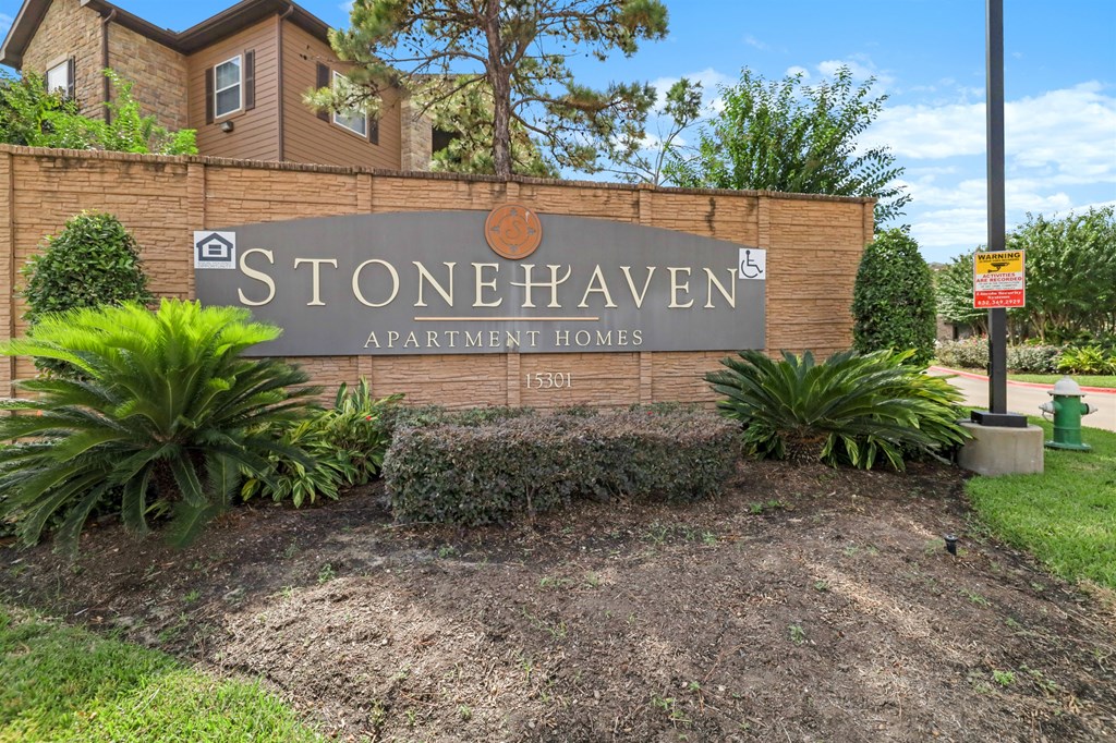Stonehaven Apartment Homes sign in front of a building.