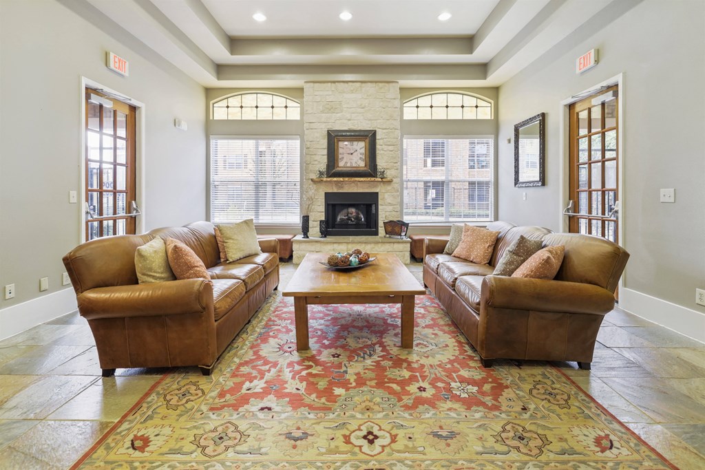 A living room with a fireplace and two couches.