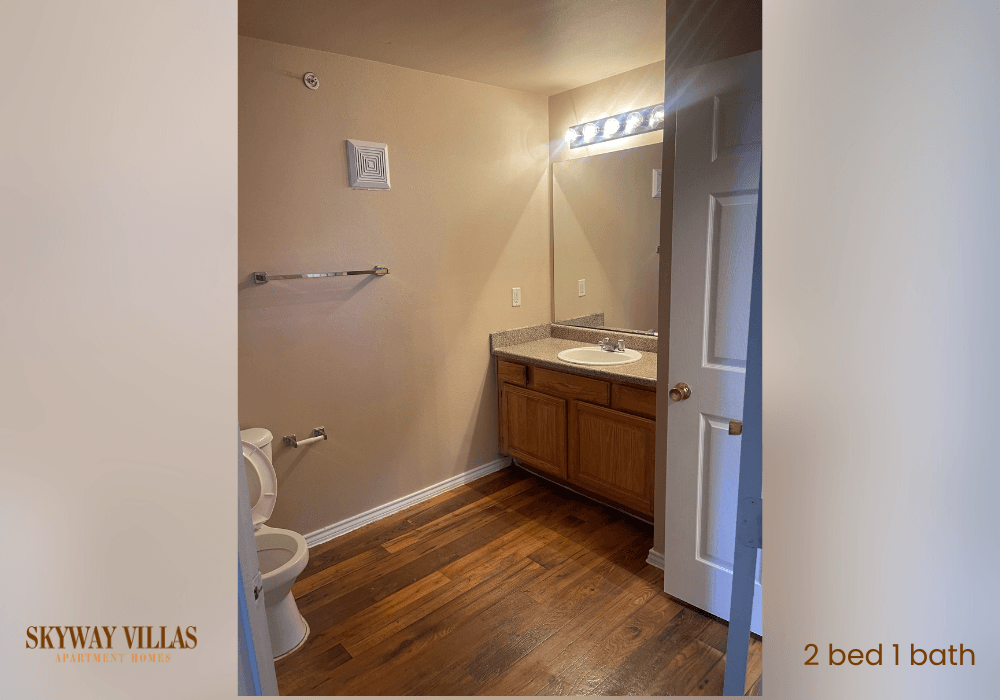 a full view of a bathroom with a toilet sink and mirror