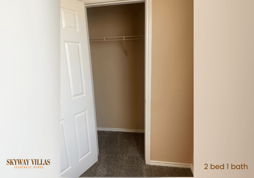 the closet in a small room with a white door