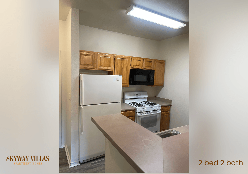 a kitchen with white appliances and wooden cabinets